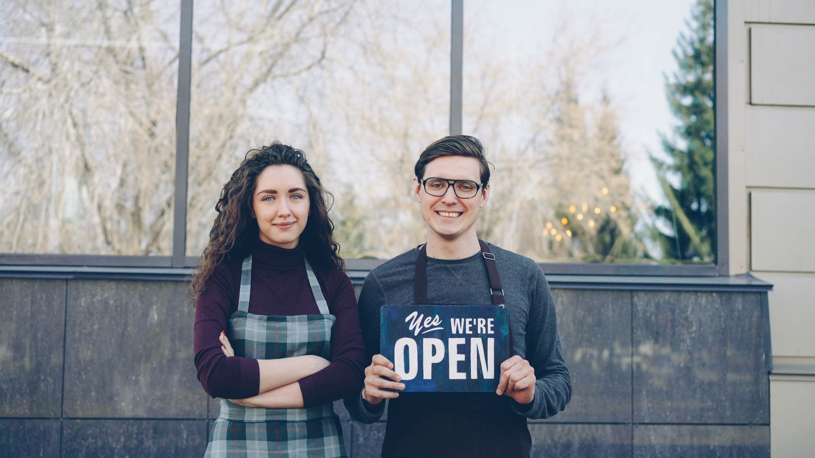 Local business owner in front of their storefront