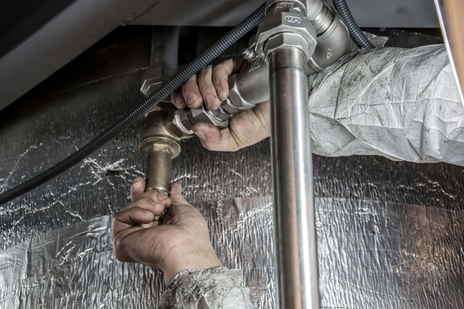 Plumber contractor working on a pipe