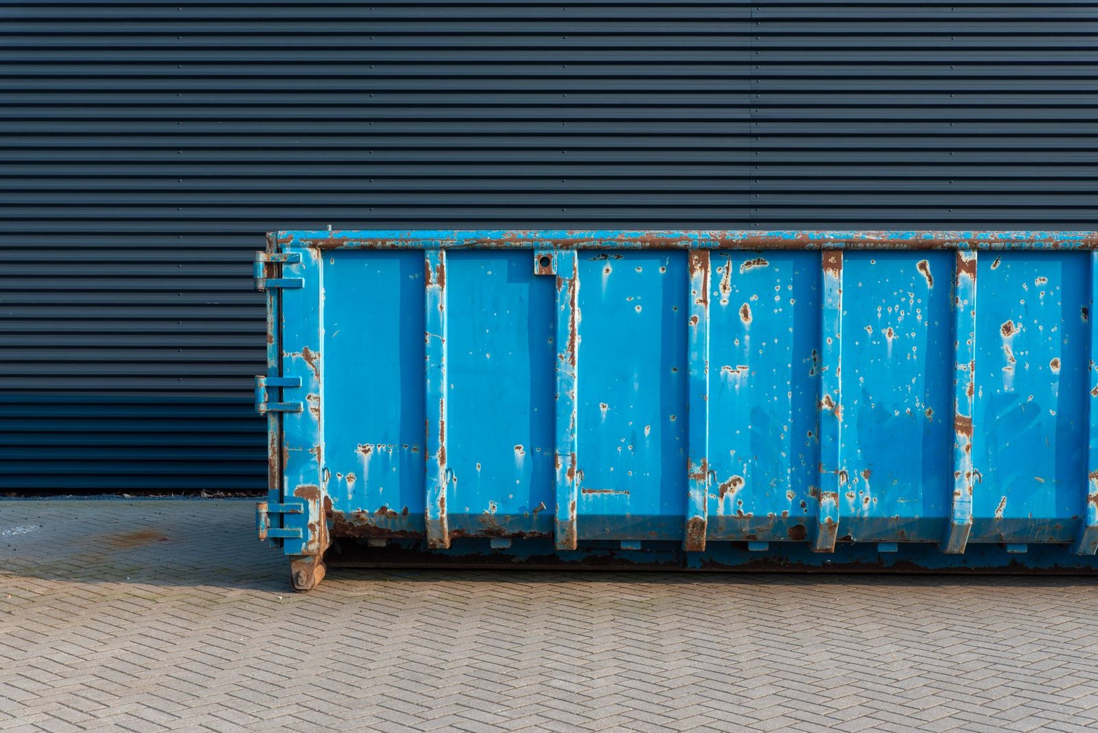 Waste management truck loading a dumpster